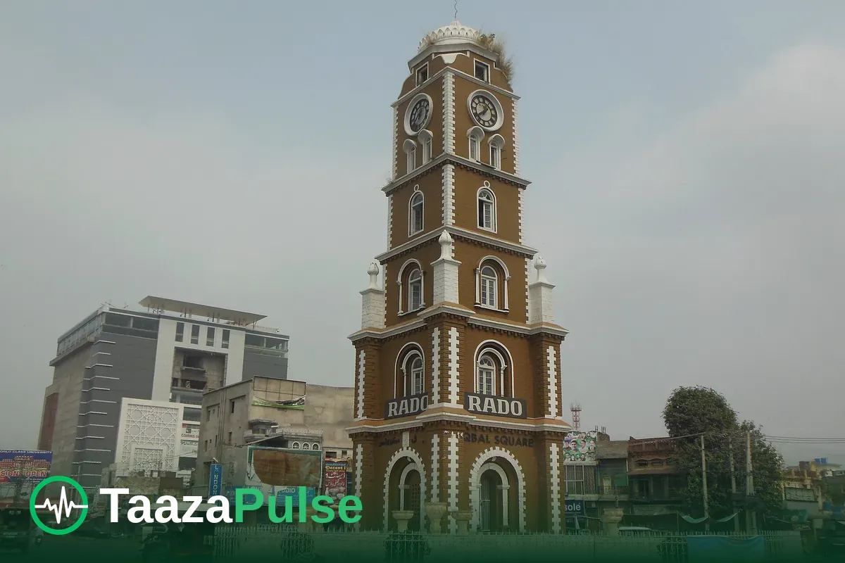 The Clock Tower in Sialkot, with shops and traffic around its base