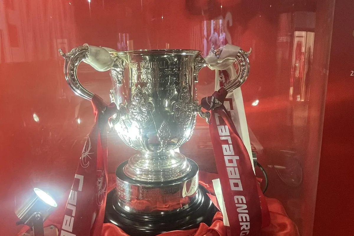 The EFL Cup trophy, known as the Carabao Cup, on display with red ribbons