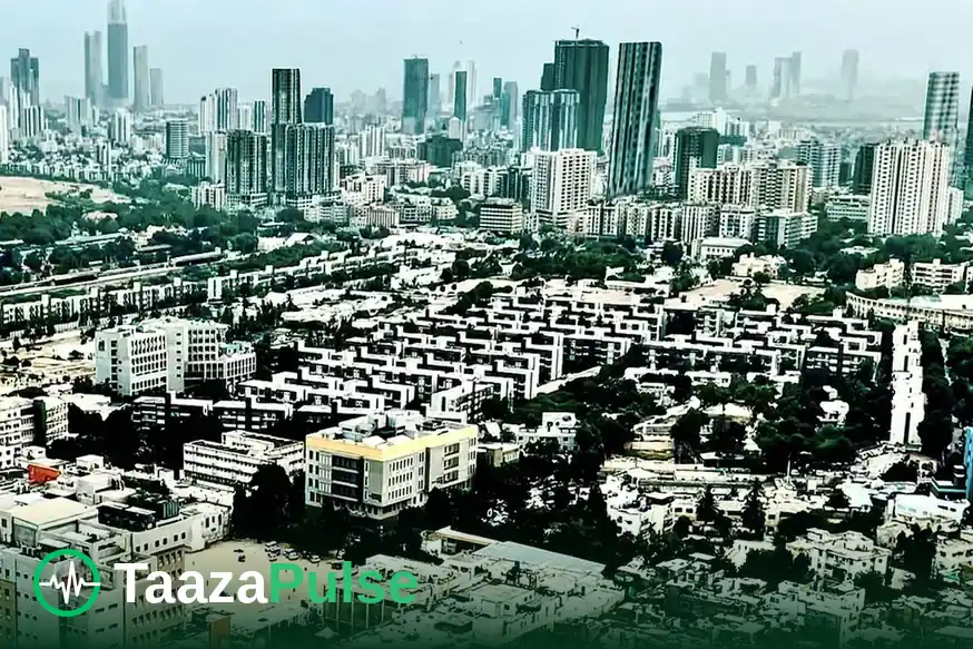 An aerial view over Karachi's dense neighbourhoods towards the high-rise skyline