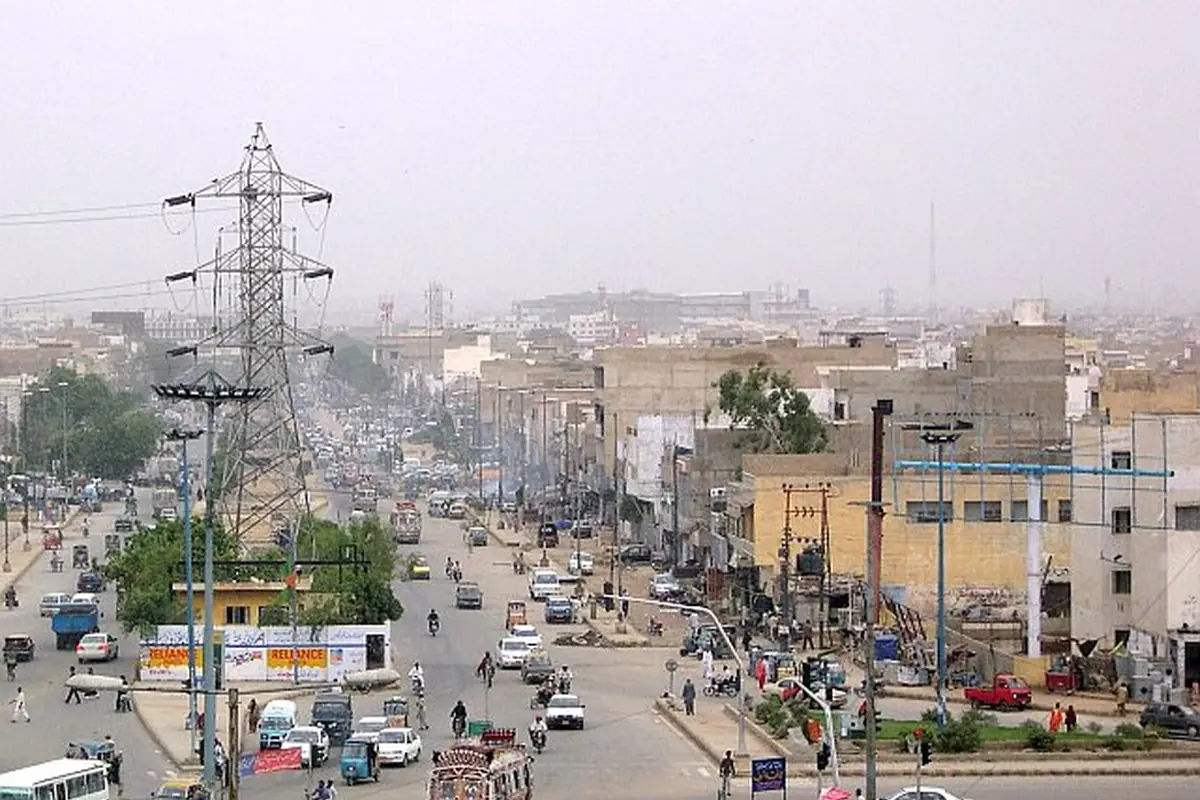 Traffic and dense low-rise neighbourhoods at Nagan Chowrangi, Karachi