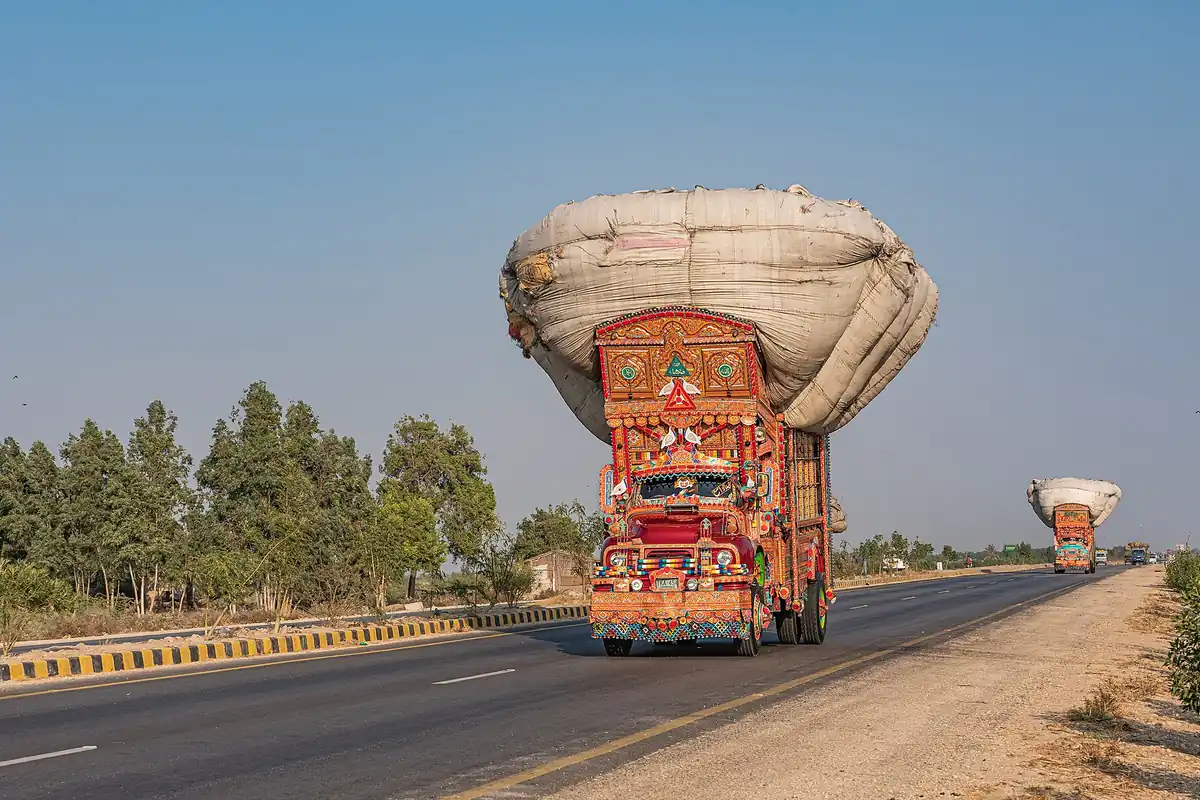 Trucks on a highway in Pakistan carrying goods
