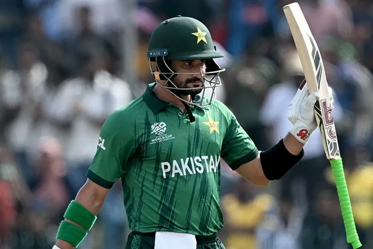 Sahibzada Farhan raises his bat after reaching a milestone