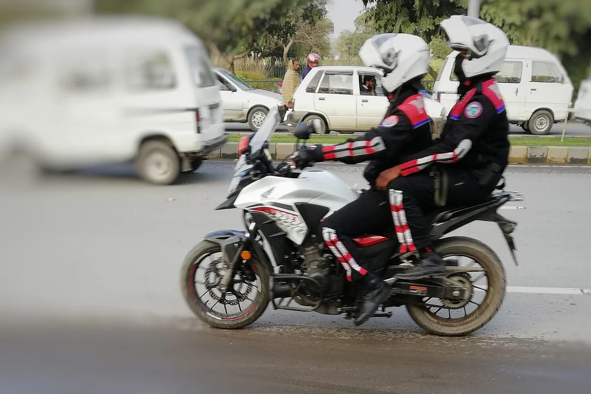 Two Dolphin Force police patrollers on a motorcycle on a Punjab road