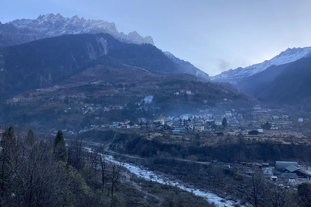 A Himalayan mountain town in a valley at dusk