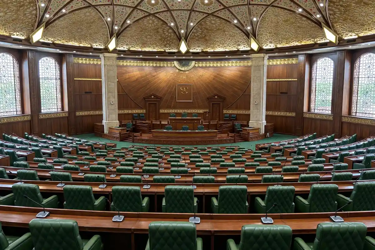 Empty provincial assembly hall with rows of seats and desks