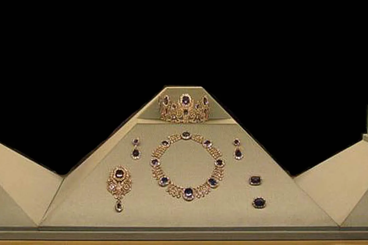 French crown jewels on display, including crowns and a sapphire necklace set