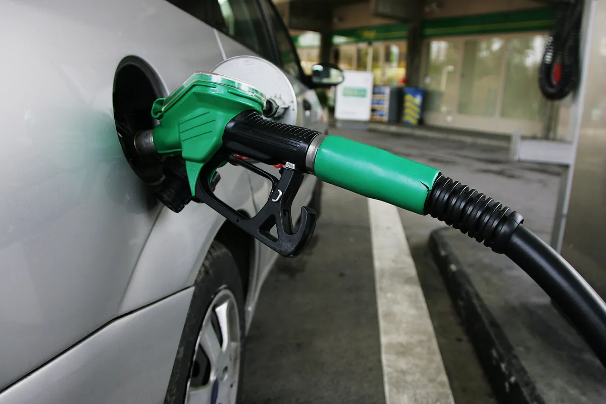 A fuel nozzle filling a car at a petrol station