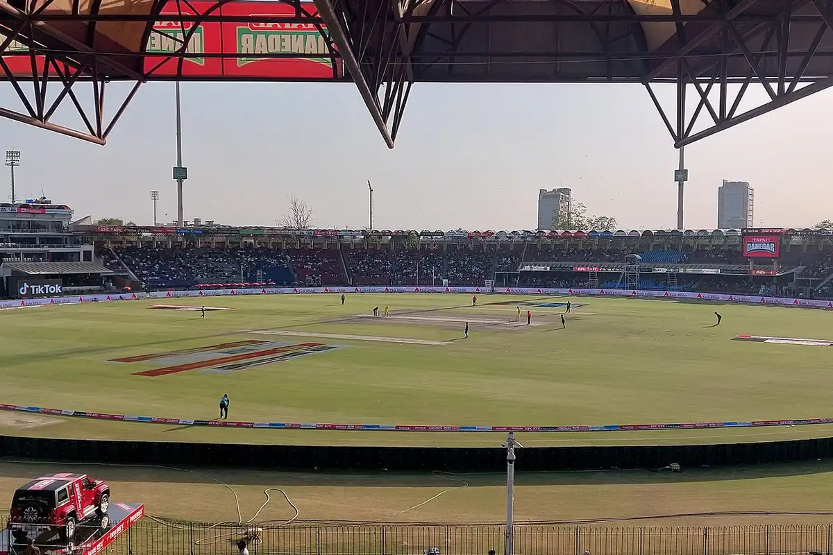 A daytime cricket match in progress at Gaddafi Stadium, Lahore