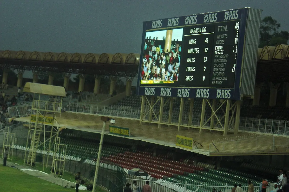 The large scoreboard at Gaddafi Stadium showing a match score