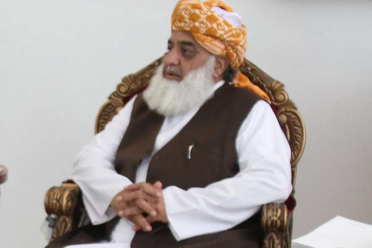 Maulana Fazlur Rehman, chief of the JUI-F, seated in an orange turban