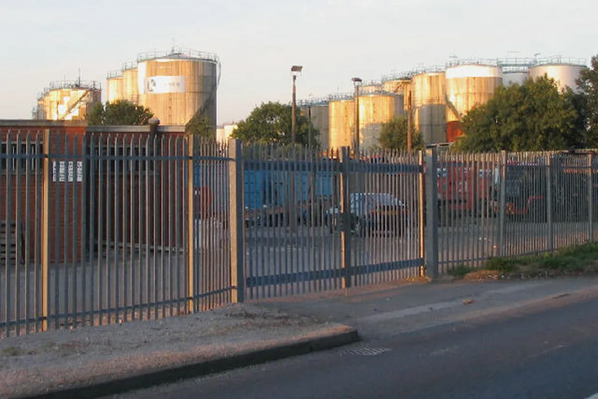 Oil storage tanks behind a fence