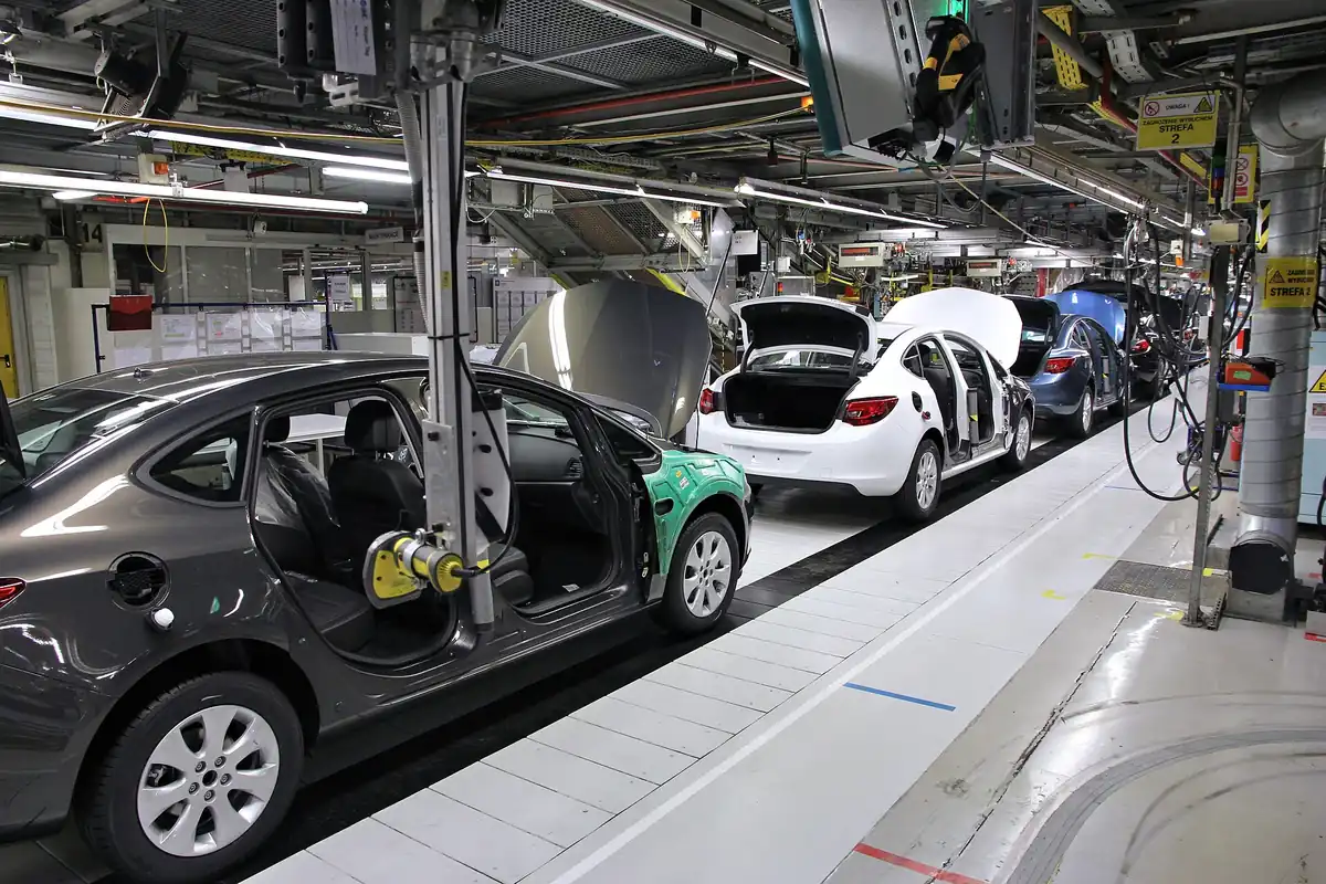 Cars on a vehicle assembly line inside a factory