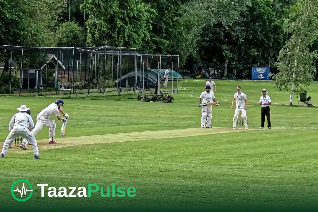 A batter plays a shot during a club cricket match on a green outfield