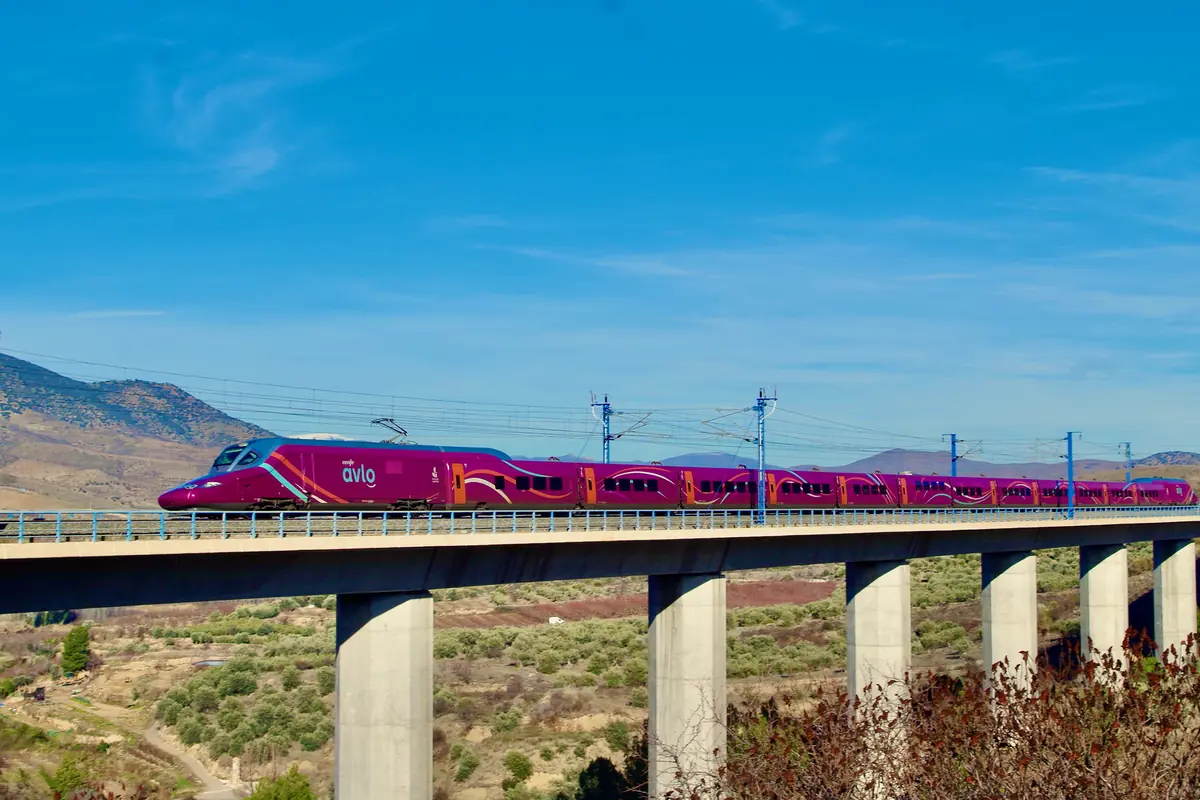 A Renfe Avlo high-speed train crossing a viaduct in Spain