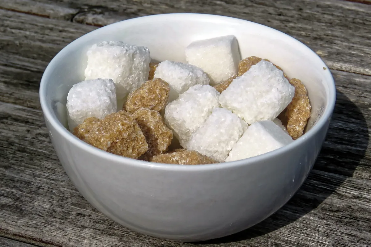 White and brown sugar cubes in a white bowl