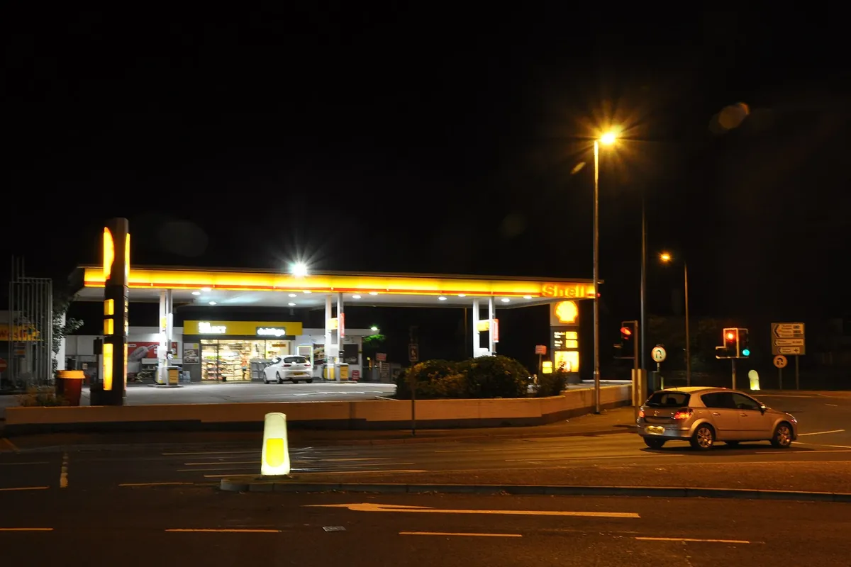 A Shell petrol station illuminated at night
